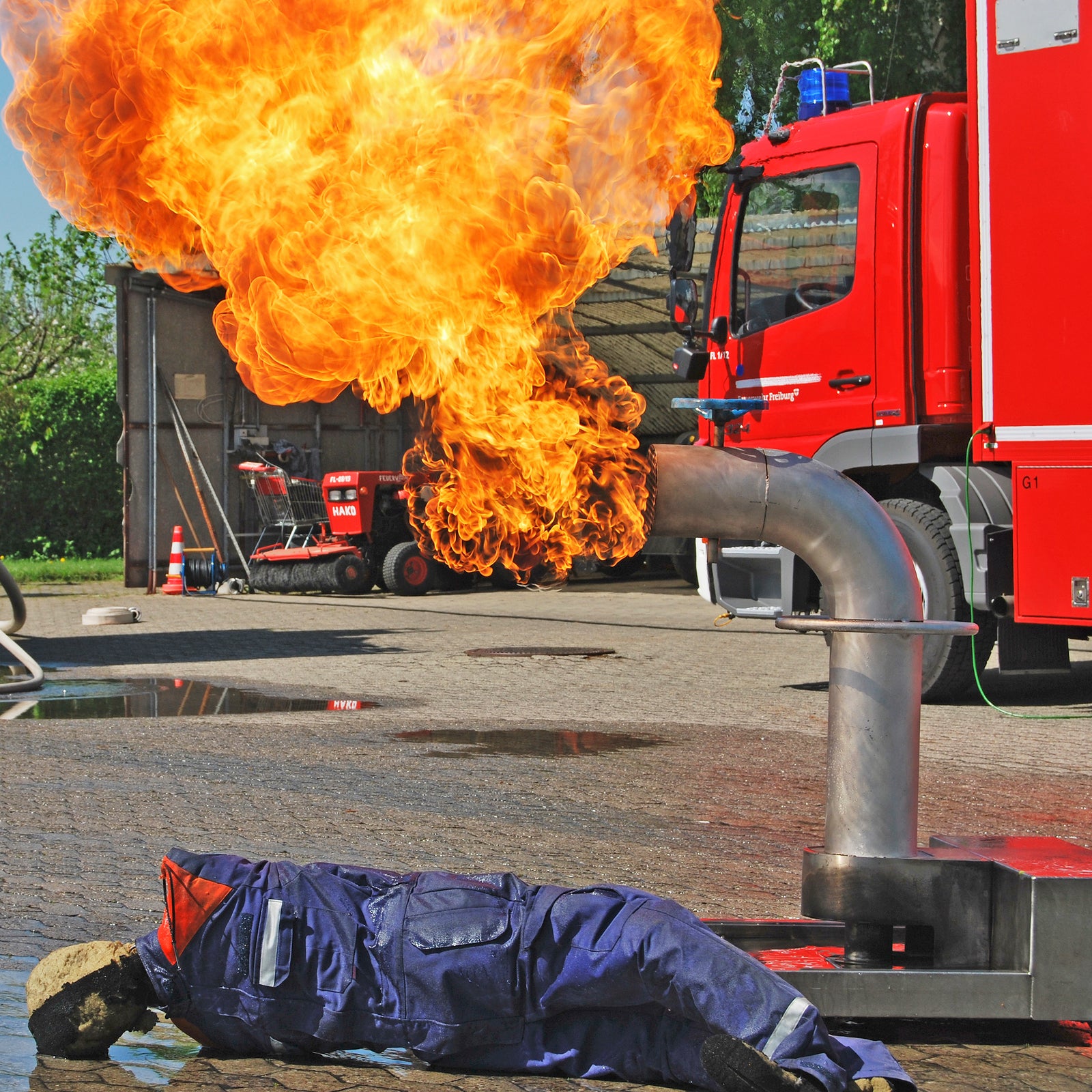 Use of the AISCO Firetrainer E1502 with burning industrial valve and fire drill dummy in a realistic fire brigade exercise