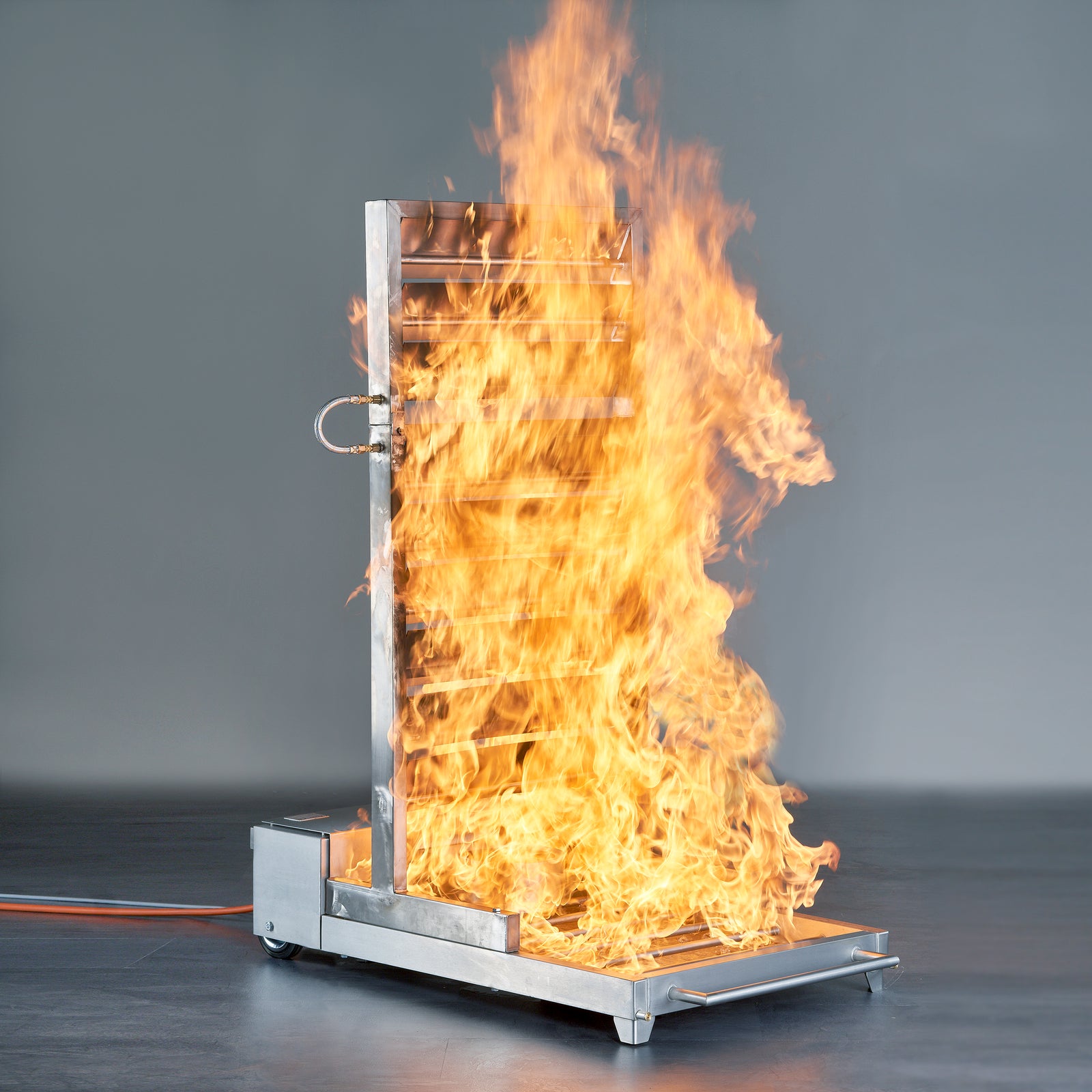 AISCO Firetrainer E1502 in use with a burning barrel fire attachment for realistic depiction of industrial fires during fire department drills